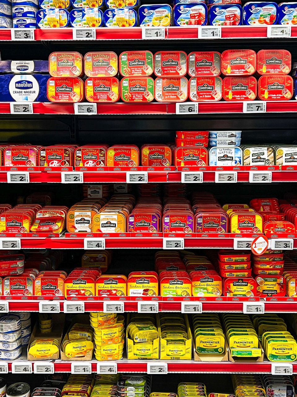 Free A vibrant assortment of canned fish in a French supermarket aisle. Stock Photo